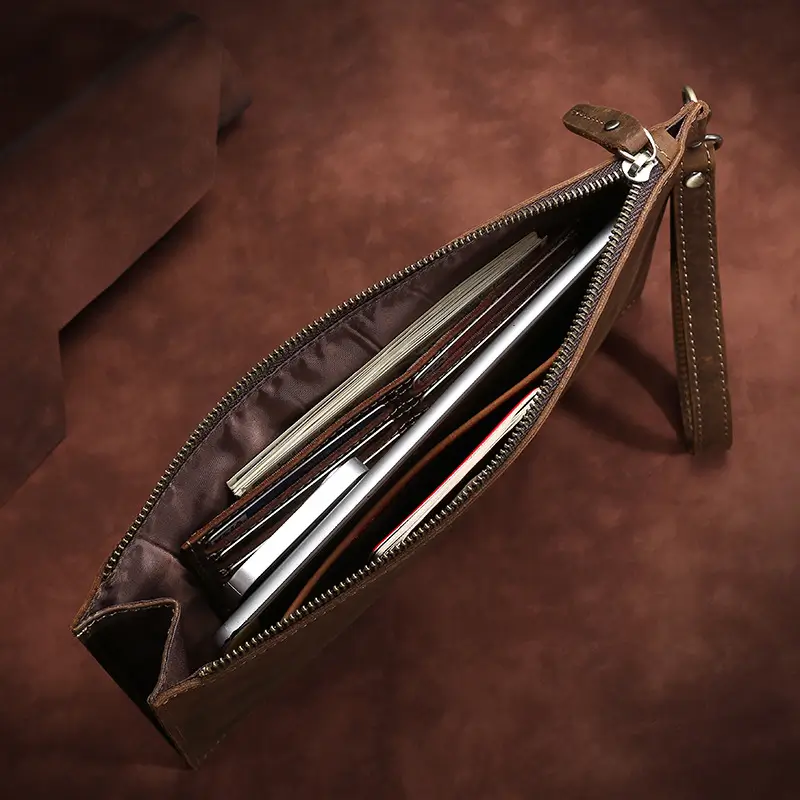Zipper detail of a brown leather clutch bag